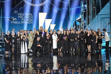 Uczestnicy 51. Festiwalu Polskich Filmów Fabularnych pozują do grupowego zdjęcia na scenie po uroczystej gali wręczenia nagród.